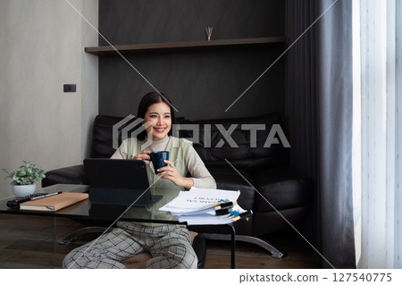 Asian business woman relax and working on laptop remotely from home. work from home concept 127540775