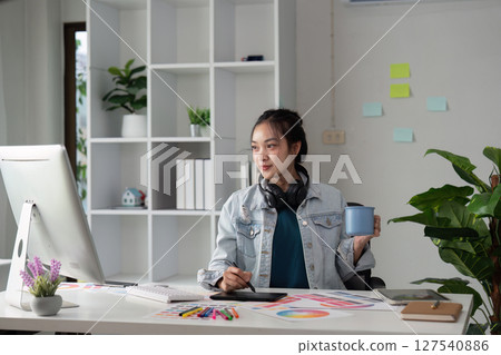 Graphic or UI designer work on computer laptop and with tablet after brainstorming unique design with professional developer UX team 127540886