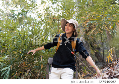 LGBT gay woman with backpack walk along forest path while hiking and camping on the weekend LGBT gay woman with backpack walk along forest path while hiking and camping on the weekend 127540962