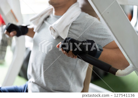 Strength Training and Fitness. Man exercising on weight machine in gym. Strength Training and Fitness. Man exercising on weight machine in gym. 127541136