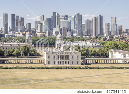 the iconic Queen's House and the Old Royal Naval College in the foreground, with the modern skyscrapers of Canary Wharf forming the distinctive skyline in the background. 127541435