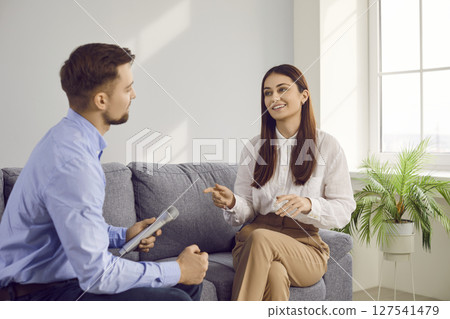 Successful famous young actress giving interview to male host on television show Successful famous young actress giving interview to male host on television show 127541479