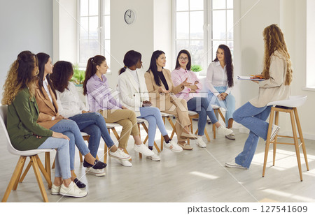 Group of business women on a meeting listening a woman speaking at the conference. Group of business women on a meeting listening a woman speaking at the conference. 127541609