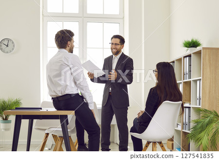 Team of business people together with their manager meeting and having a discussion 127541835