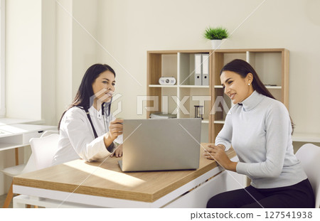 Female patient visiting a doctor at the medical office during medical examination. 127541938