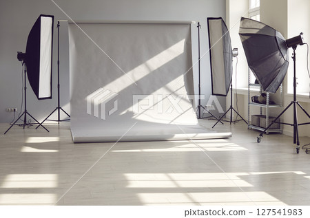 Interior of an empty modern photo studio with professional lighting equipment. 127541983