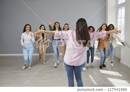 Team of happy joyful business women celebrating success of their colleague together 127541990