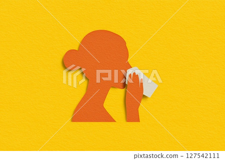Orange silhouette of a woman with white handkerchief paper cutout style set against a vibrant yellow background, symbolizing the concept of allergy 127542111