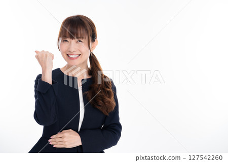 Middle-aged woman in a suit doing a fist pump Middle-aged woman in a suit doing a fist pump 127542260