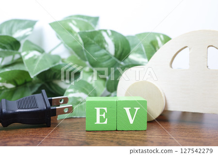 EV and power plug: An eco-friendly image expressing electric vehicles and environmental friendliness 127542279