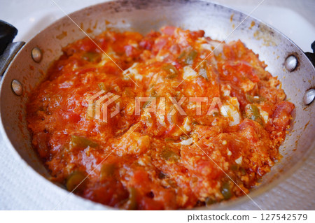 Turkish Menemen omelet in a frying pan. . 127542579