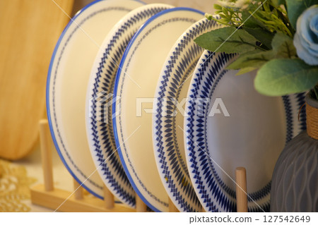 round bowl or ceramic plate on kitchen table. 127542649
