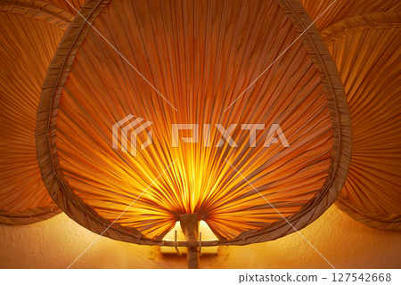 An Elegant Pleated Lampshade that provides a Warm and Inviting Glow 127542668