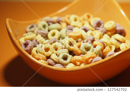 Colorful cereal in a bowl on a bright surface 127542702