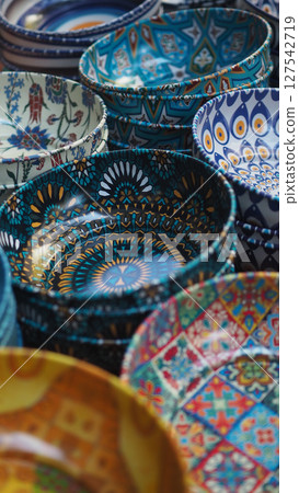 Colorful ceramic bowls displayed at a market 127542719