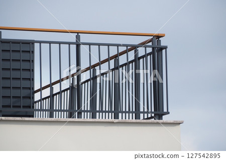 Modern balcony railing design with cloudy sky backdrop Modern balcony railing design with cloudy sky backdrop 127542895