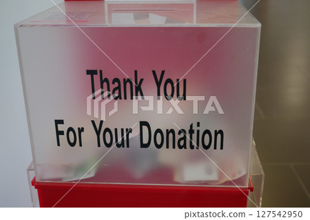Donation box encouraging community support and generosity 127542950