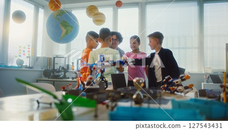 Young Teacher and Kids Doing Team Huddle Gesture in Multiethnic Classroom Young Teacher and Kids Doing Team Huddle Gesture in Multiethnic Classroom 127543431