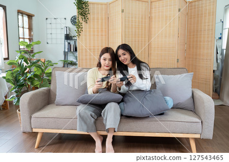 gay couple hug on sofa to relax together in healthy relationship love connection. Lgbtq couple concept 127543465