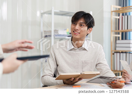 Close up ux developer and ui designer brainstorming interface wireframe design.Creative digital development agency 127543588