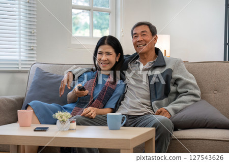 Relaxed elderly couple enjoying weekend together at home. senior retirement concept 127543626