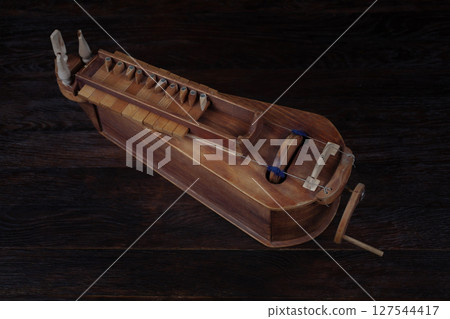 The hurdy gurdy, stringed musical instrument. 127544417