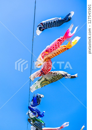 Carp streamer swimming in the blue sky 127545901