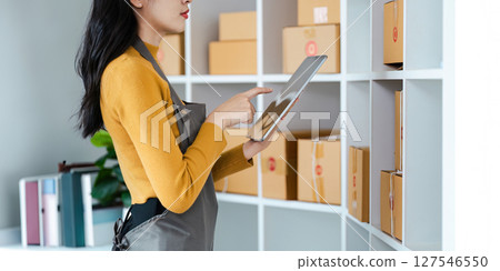 Entrepreneur startup business woman sme holding tablet. Small Online Business Owner, Online Marketing and Product Packing and Delivery Service. E-commerce concept 127546550