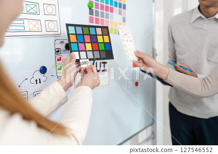 UI designers present to team about color design of logo during application design brainstorming. Creative digital development agency. UX UI concept 127546552