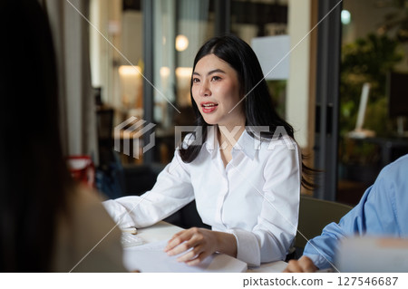 Diverse executive business team group discuss project at boardroom meeting Diverse executive business team group discuss project at boardroom meeting 127546687