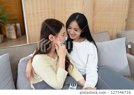 gay couple hug on sofa to relax together in healthy relationship love connection. Lgbtq couple concept gay couple hug on sofa to relax together in healthy relationship love connection. Lgbtq couple concept 127546716
