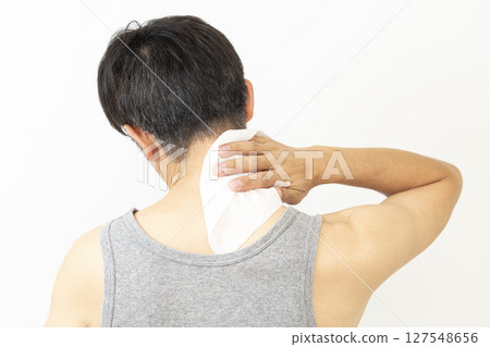 A man wiping his body with a sweat wipe, white background 127548656