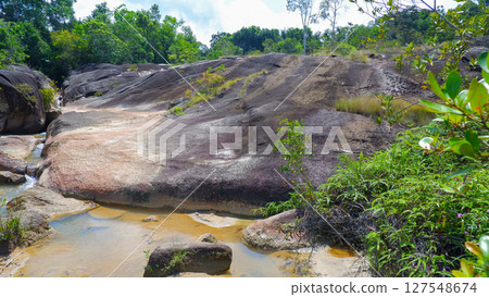 Rocky Stream Bed and Slopes with Tropical Forest in Palembang 127548674
