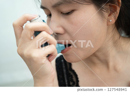 Asthma and chronic obstructive pulmonary disease COPD, Asian teenage using metered dose inhaler MDI. 127548941