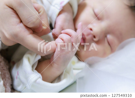 Baby's small hand Newborn holding finger 127549310