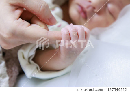 Baby's small hand Newborn holding finger 127549312