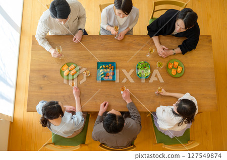 Aerial view of Japanese men and women having a home party Aerial view of Japanese men and women having a home party 127549874