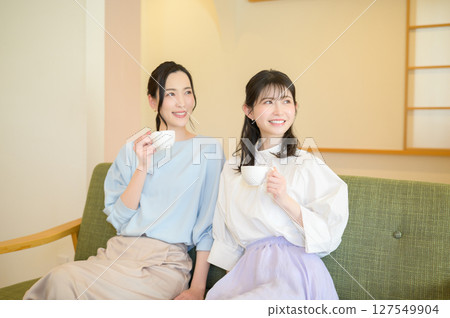 Two Japanese women relaxing in the living room 127549904