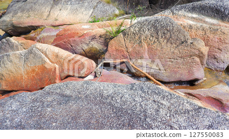 Rocky Stream with Smooth Granite Slopes and Lush Tropical Forest in Palembang 127550083