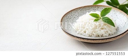 Cooked Jasmine Rice Garnished with Fresh Herbs on Ceramic Plate 127551553