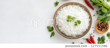 Freshly Cooked Jasmine Rice Garnished with Aromatic Herbs on Ceramic Platter 127551566