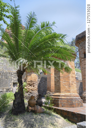 Palm tree and ancient jugs in Po Nagar Cham Towers built in the 8th century in Nha Trang, Vietnam 127553028