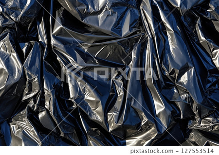 Stretched Black Plastic Surface With Intricate Texture and Reflections 127553514