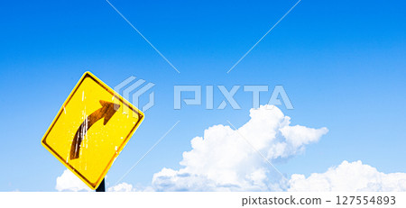 A simple landscape with blue sky, clouds and a right curve sign A simple landscape with blue sky, clouds and a right curve sign 127554893