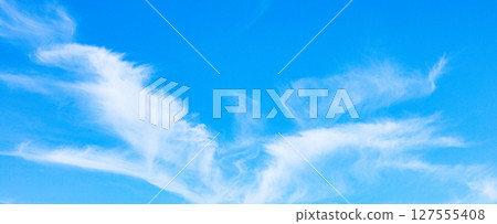 A landscape with clouds that resemble wings flapping in the sky A landscape with clouds that resemble wings flapping in the sky 127555408