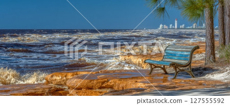 A sea beach bench in Kolobrzeg is overwhelmed by floodwaters from a storm 127555592