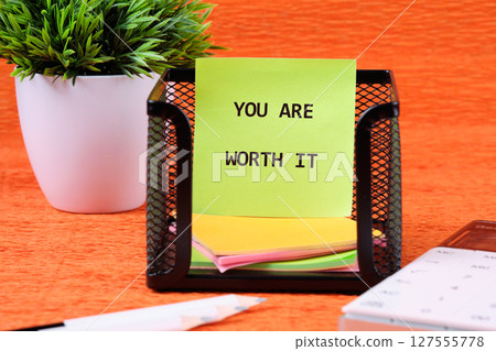 YOU ARE WORTH IT words written on colorful stickers in a black mesh holder YOU ARE WORTH IT words written on colorful stickers in a black mesh holder 127555778