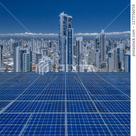 The concept of sustainable resources is represented by a photovoltaic power plant situated on the roof of a residential building under sunny conditions 127556058