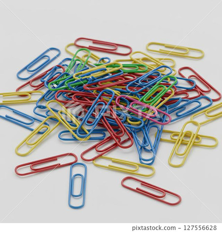 Blank pile of colored paperclips mockup, isolated on white background. Office supply design template for stationery, admin, or school use. 127556628