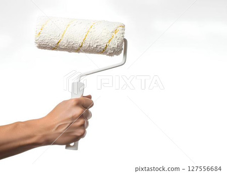 Hand holding a foam paint roller mockup isolated on white background, for DIY tutorials, renovation branding, or home improvement projects. 127556684